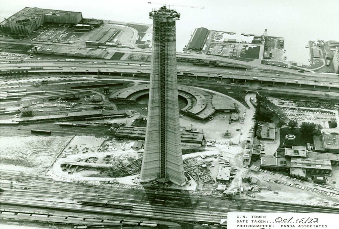 A south-facing aerial view of the CN Tower shows that it is now a few hundred feet tall in October 1973.