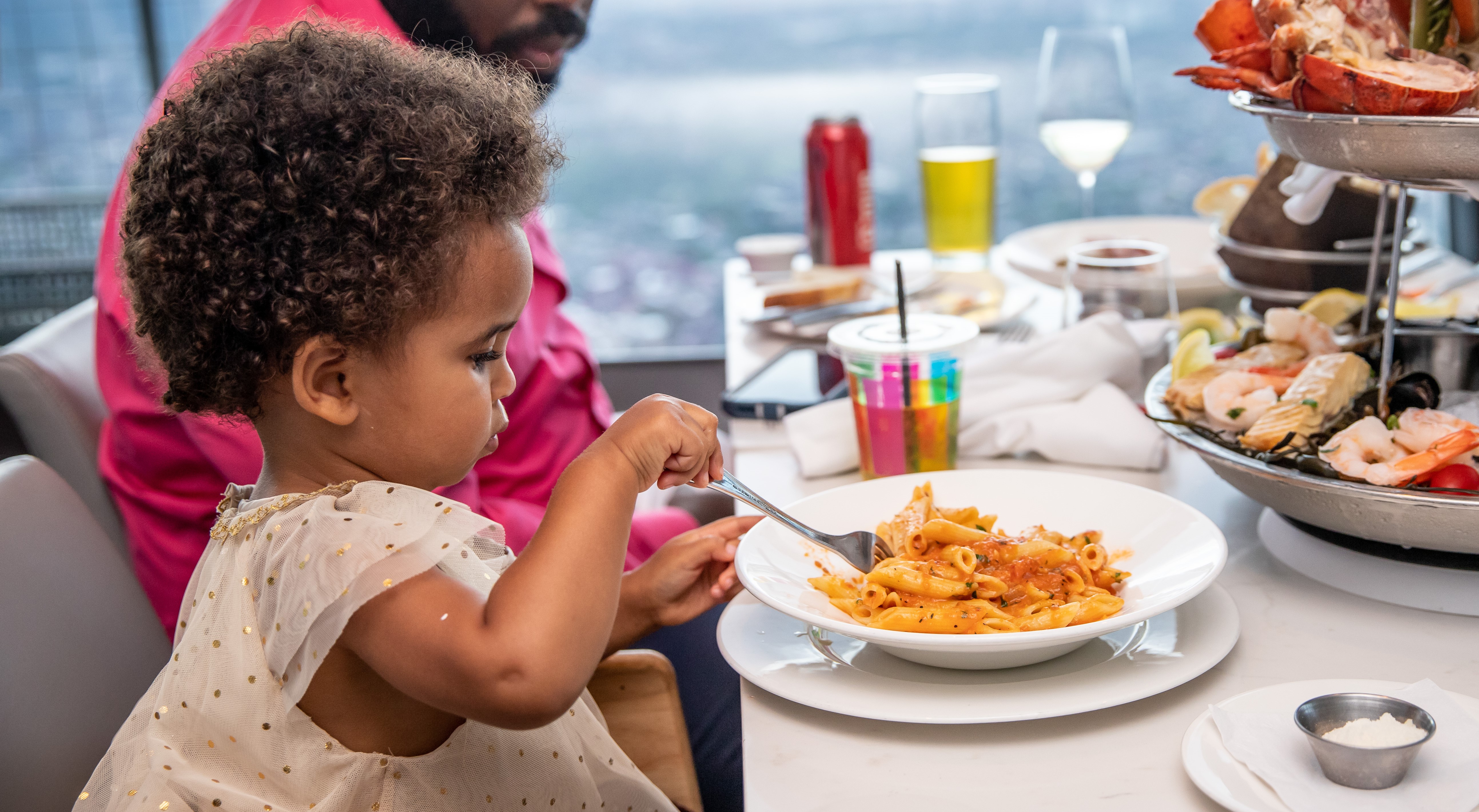 young child eating pasta at 360 restaurant