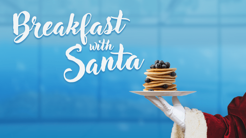 Breakfast with Santa: santa's hand holding a plate of blueberry pancakes on with the view from the observation level of the CN Tower in the back
