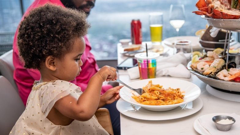 young child eating pasta at 360 restaurant
