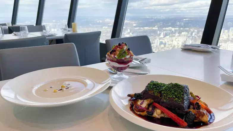 The entire Indigenous menu on a table at 360 overlooking the view of the city of Toronto.