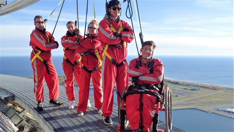 group of 5 people on edgewalk, one participant using a wheelchair