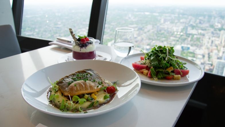 The entire Indigenous menu on a table at 360 overlooking the view of the city of Toronto.