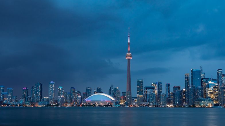 Toronto skyline at night with CN Tower lit up